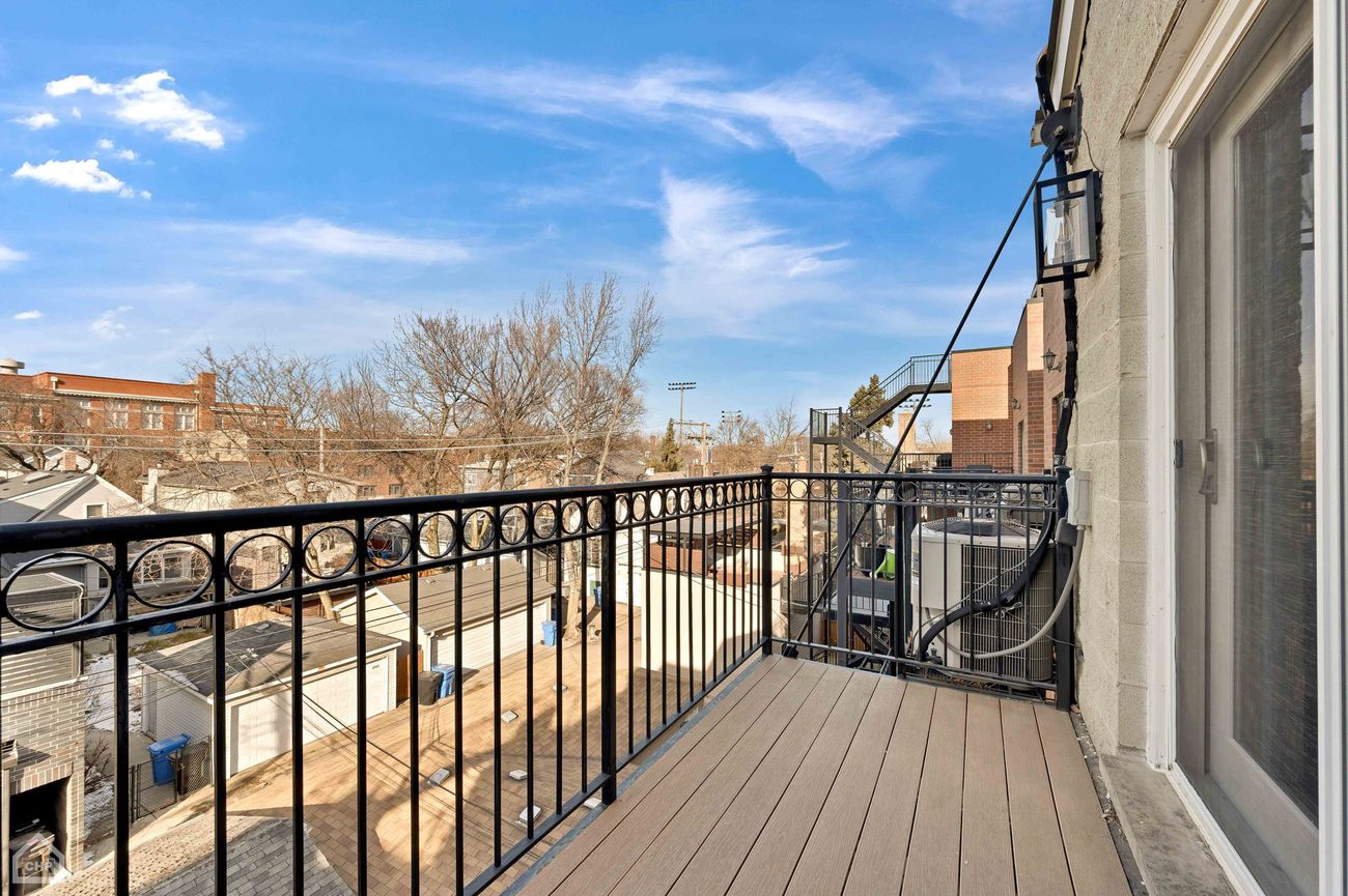 Damen Ave Condo — private balcony off the primary bedroom