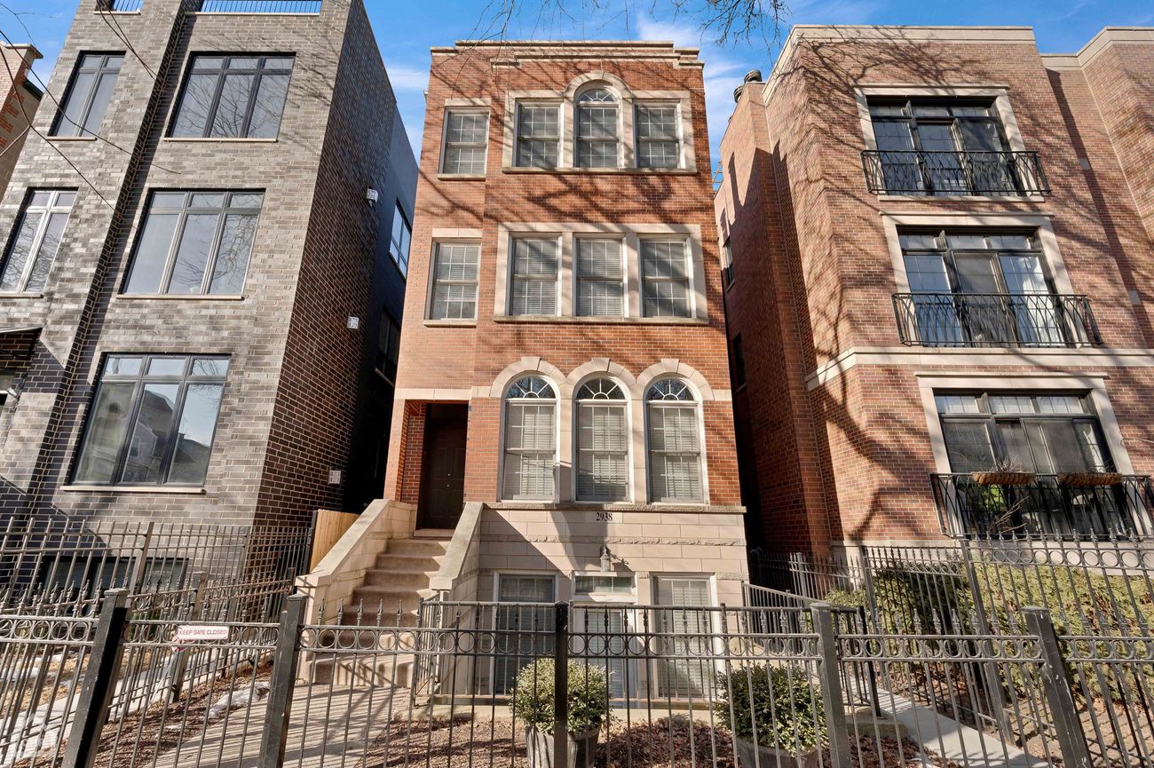 Exterior of the three-story brick building housing Damen Ave Condo