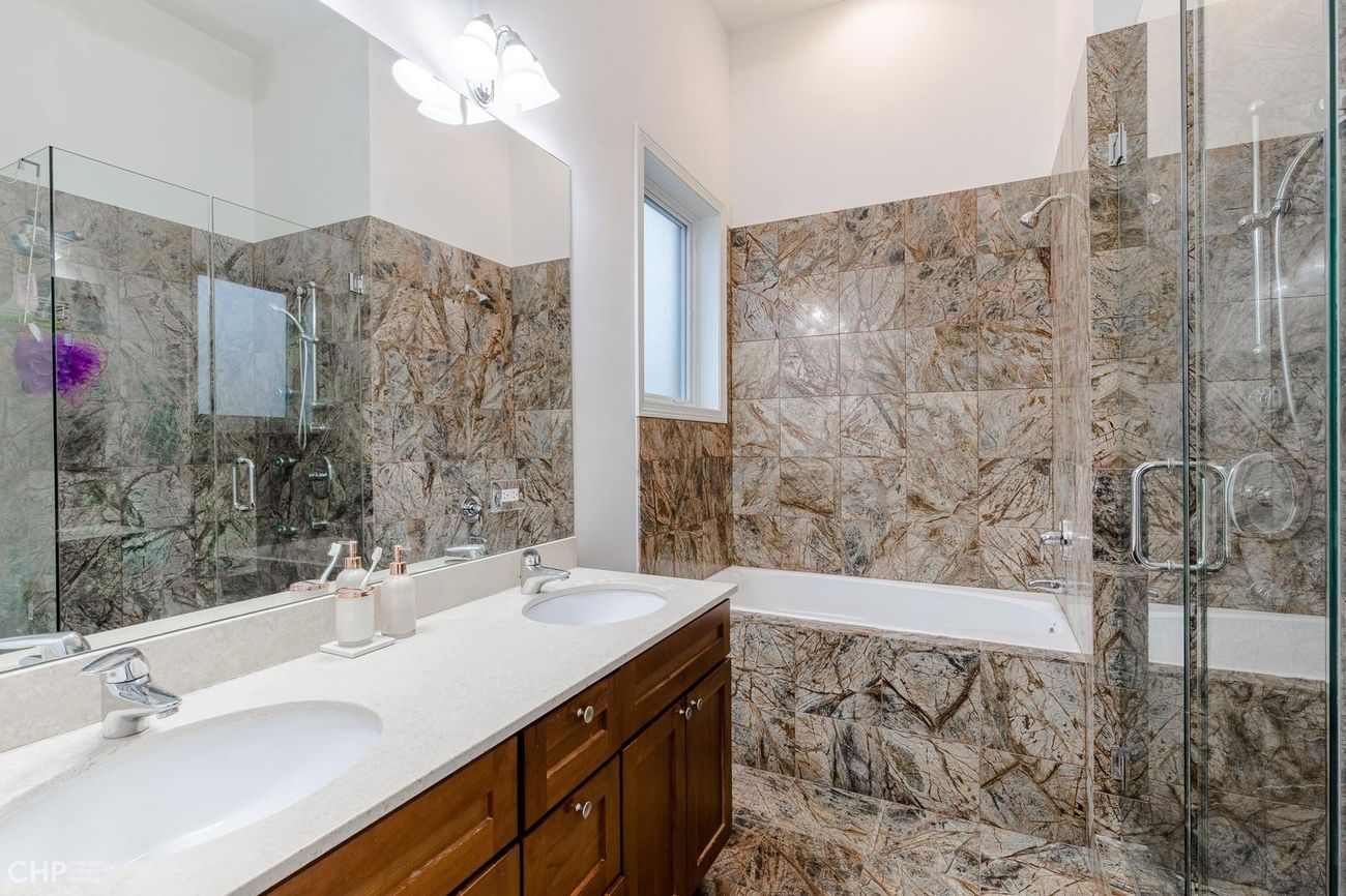Logan Square 2BD — primary bath with double vanity and soaking tub