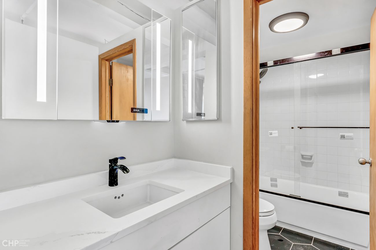 Sangamon Loft 1 — bathroom with quartz vanity and tub/shower