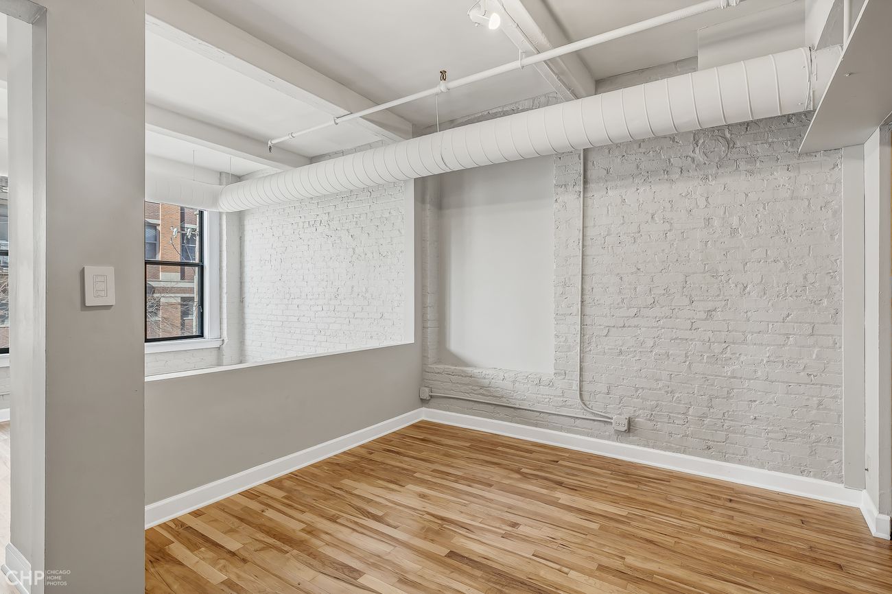 Sangamon Loft 1 — bedroom with exposed brick and closet