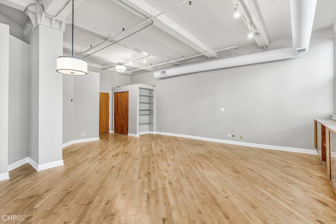 Sangamon Loft 1 — living area corner with exposed painted brick wall