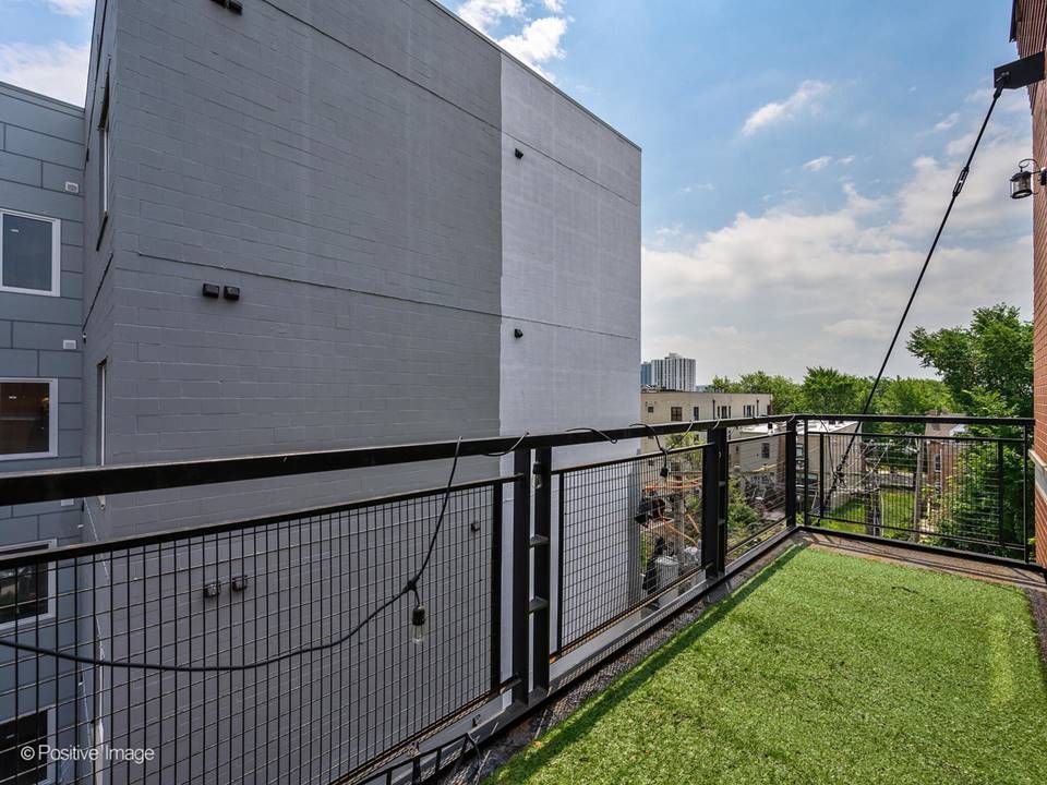 The South Leavitt — building rooftop deck with turf seating area
