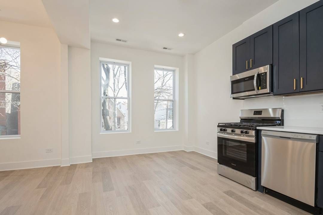 Wicker Park 3 Flat — Unit 2 kitchen with navy cabinetry, wide view