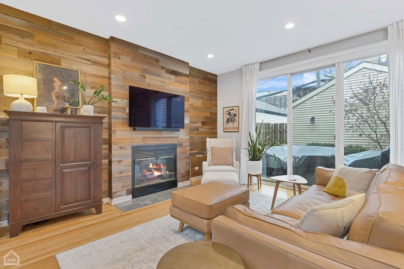 Wicker Park Gem — living room with wood accent wall and fireplace
